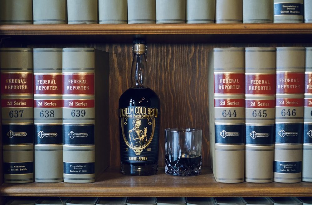 Wilhelm Cold Brew bottle and glass among the law-library shelves